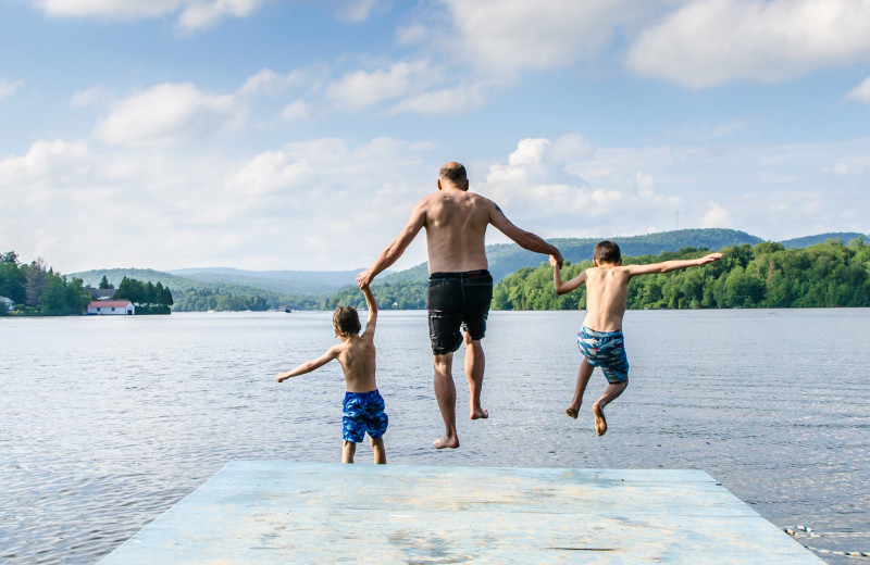 Family jumping in lake at Great Blue Resorts.