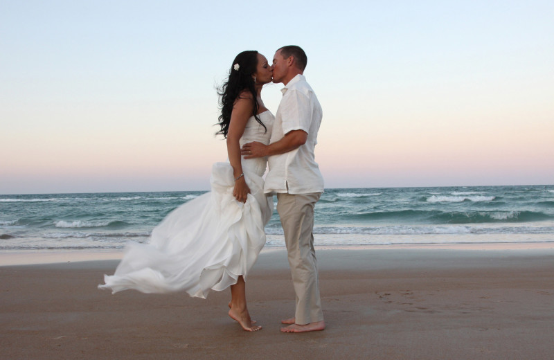 Wedding couple on beach at Coral Sands Oceanfront Resort.