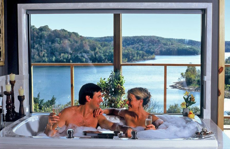 Couple in hot tub at Beaver Lakefront Cabins.