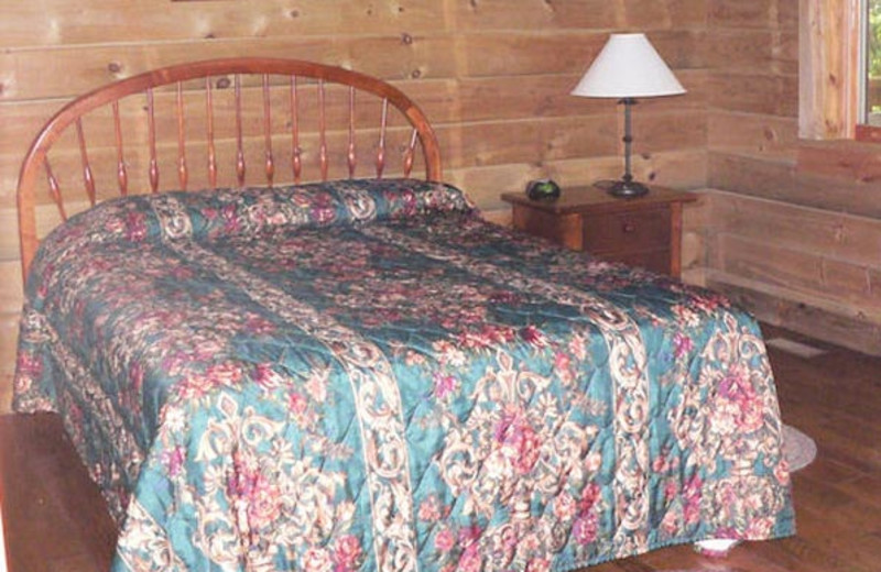 Cabin bedroom at Wilderness Presidential Resorts.