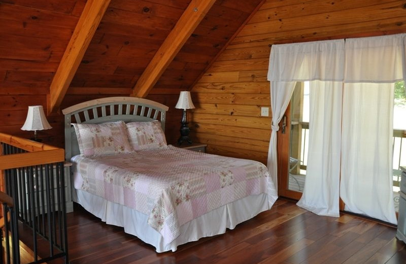 Cabin bedroom at Great Smokys Cabin Rentals.