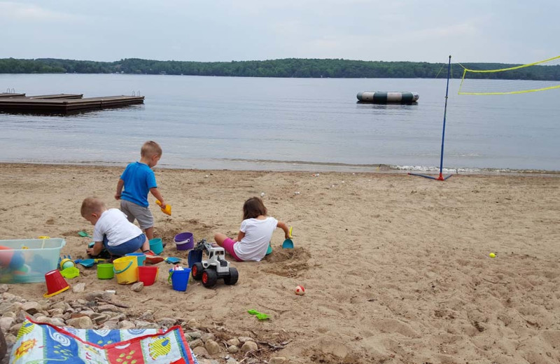 Family on beach at All-Season Cottage Rentals.