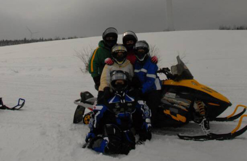 Family snowmobiling at S & J Lodge.