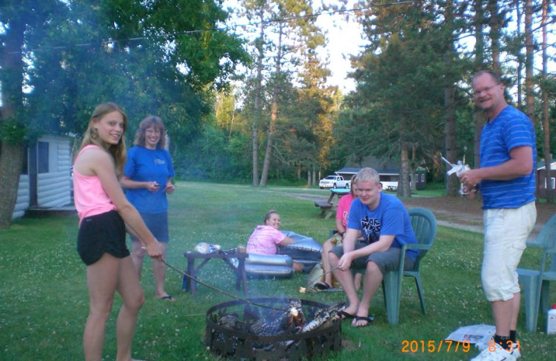 Family by campfire at Cedarwild Resort.