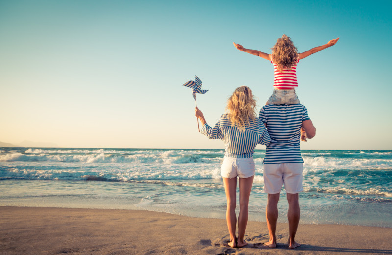 Family on beach at Exclusive Properties - Isle of Palms.