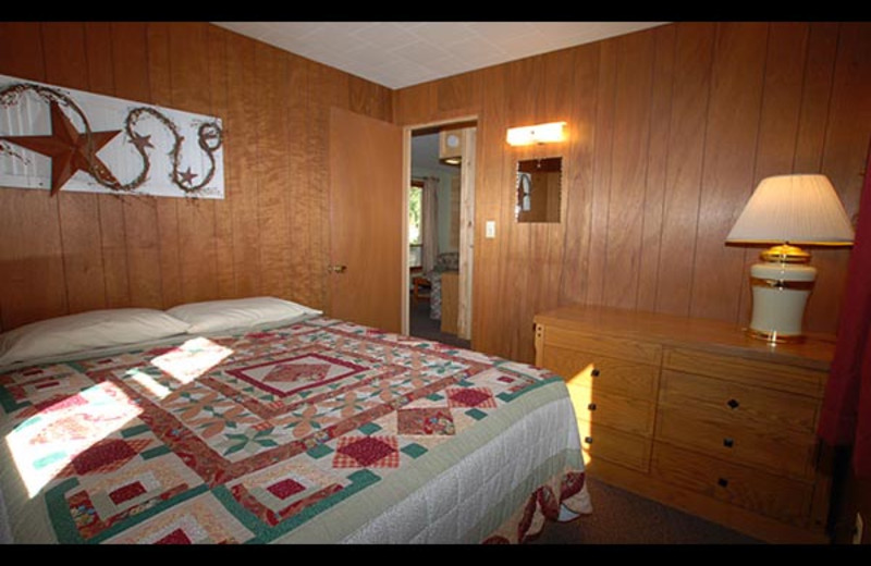 Cabin bedroom at Isle O' Dreams Lodge.