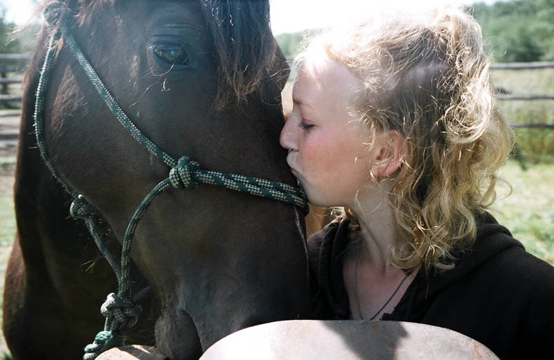 Girl kissing horse at Trailhead Ranch.