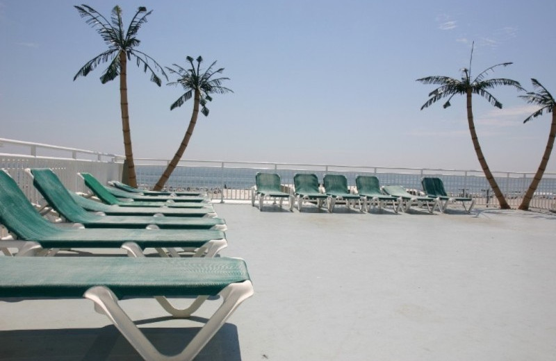 Pool lounge chairs at Surf Song Beach Resort.