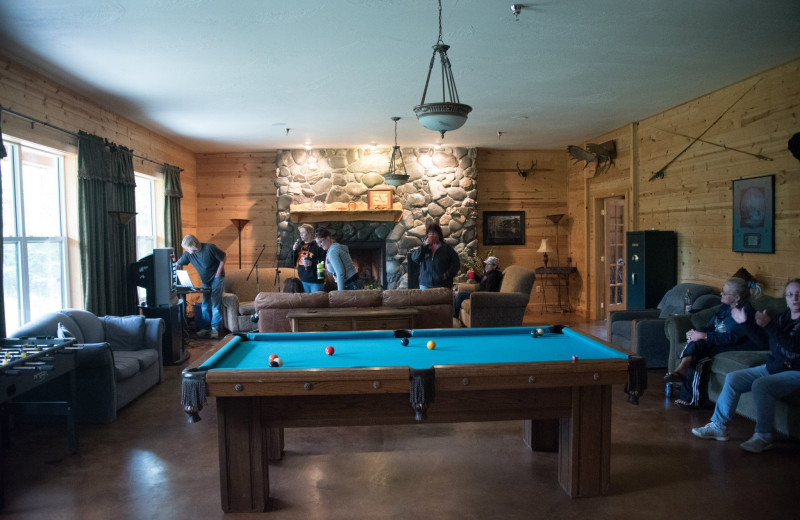 Family in rec room at  Alaska Legends Adventure Resort.