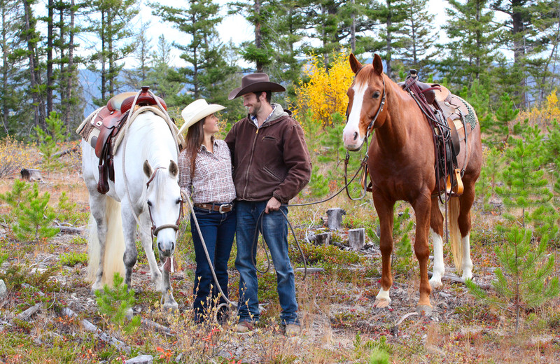 Couple horseback riding at YD Guest Ranch.