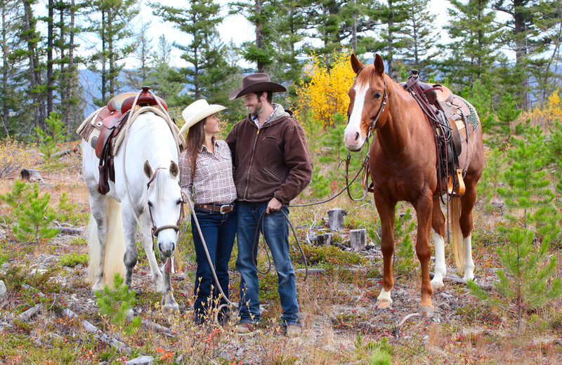 Couple horseback riding at YD Guest Ranch.
