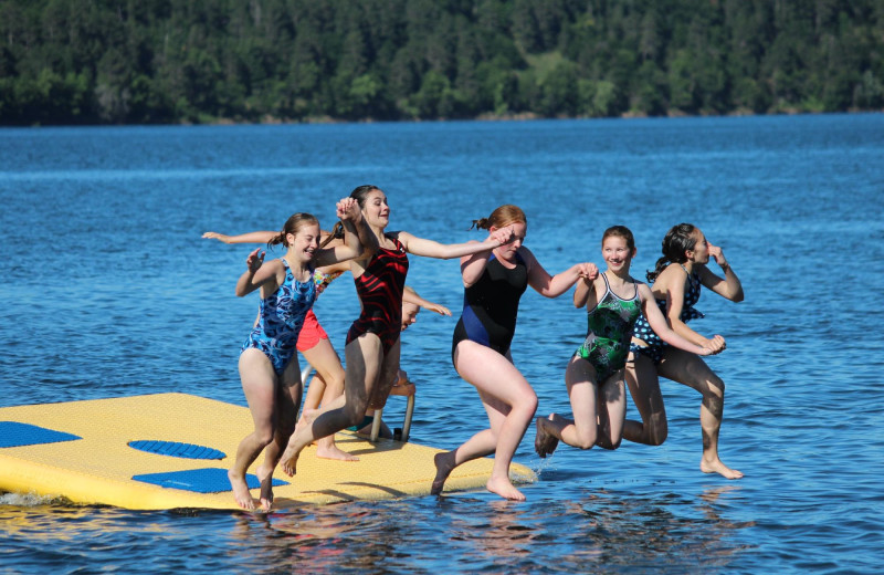 Kids jumping in lake at Auger's Pine View Resort.