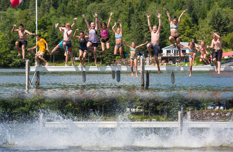 Kids safely enjoy frolic at Jackson's Lodge beach and docks on pristine international Wallace Pond.