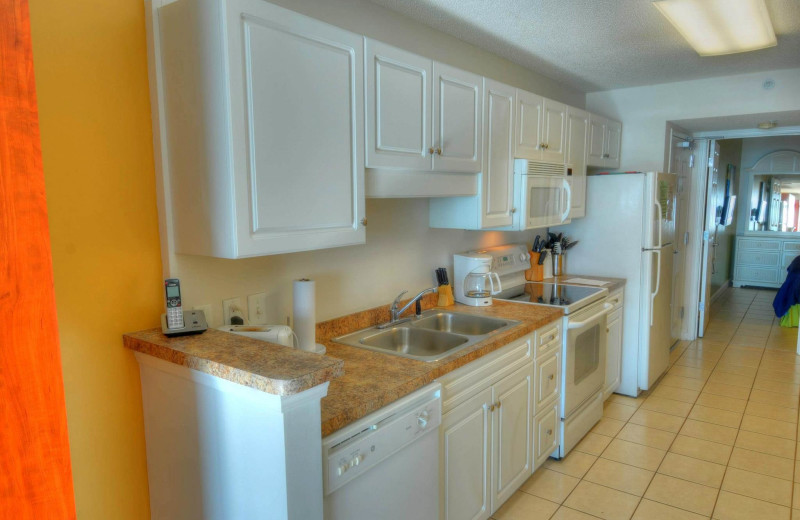 Rental kitchen at CondoLux Vacation Rentals.