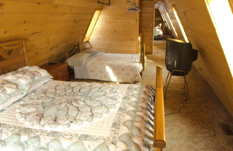 Cabin bedroom at Tri Lake Timbers Resort.