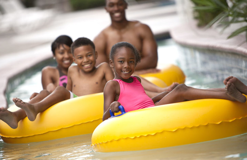 Family on lazy river at Crown Reef Resort.