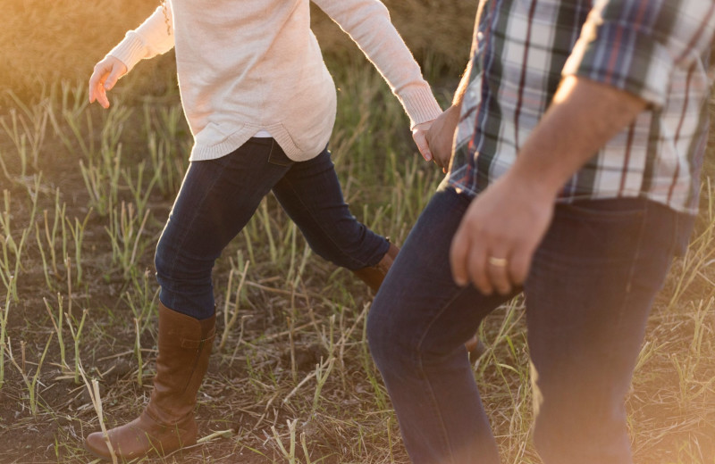 Couple holding hands at Roaring Brook Tennis and Ranch Resort.