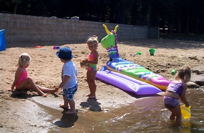Kids playing on the beach at Black Pine Beach Resort.