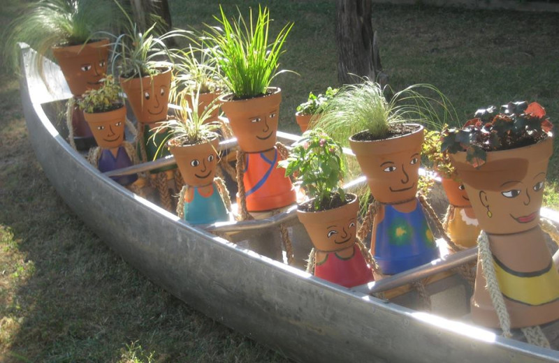 Flower pot people in canoe garden at Cliffview Resort.