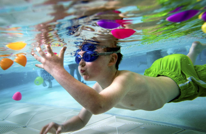 Kid in pool at Travel Resort Services, Inc.