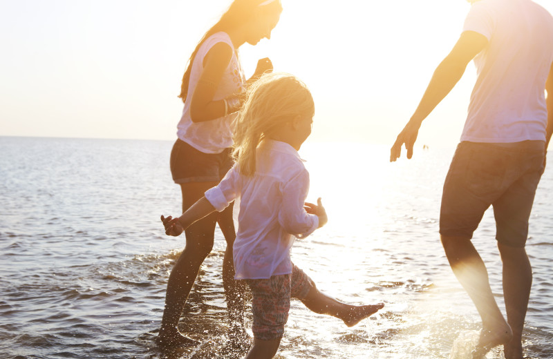 Family on beach at Topsail Realty.