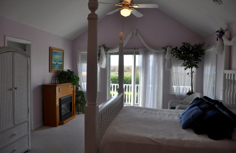 Guest room with fireplace at A Victorian On The Bay.