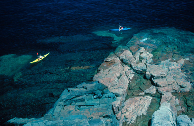 Kayaking a long the shore at Aqua Log Cabin Resort.