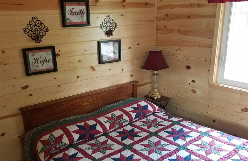 Cabin bedroom at Isle O' Dreams Lodge.