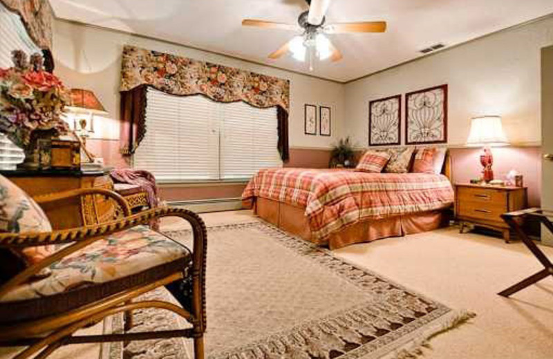 Guest bedroom with a view of the river outside at McWilliams River Home.