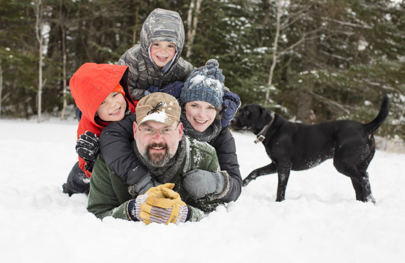 Families play in the snow at Skyport Lodge