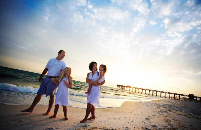 Family walking on the beach at Newman-Dailey Resort Properties, Inc. 