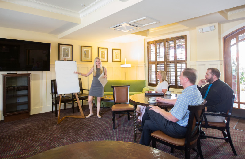 Meeting room with fixed round table seating for 20 people at Inlet Sports Lodge.