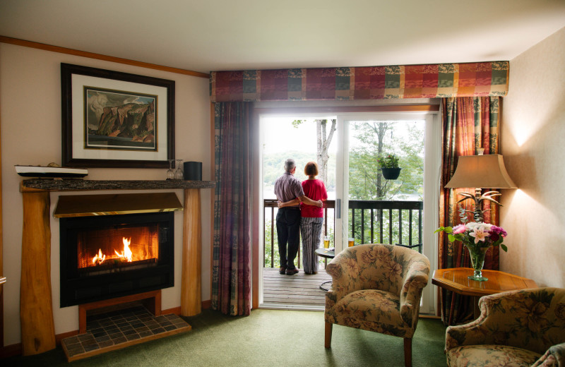 Lakeview Studio accommodation with a couple on the balcony overlooking the lake at Heather Lodge.