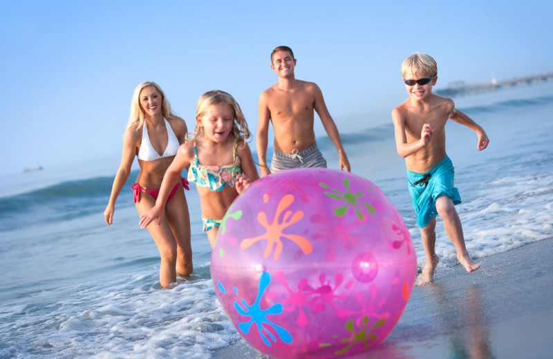 Family on beach at Crown Reef Resort.