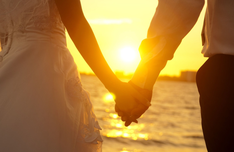 Couple holding hands at Hola Grand Faro Los Cabos.