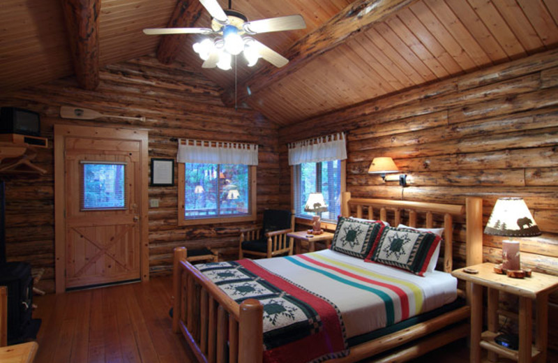 Cabin bedroom at Silverwolf Log Chalet Resort.