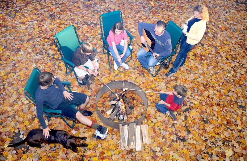 Family by the campfire at Lake George RV Park.