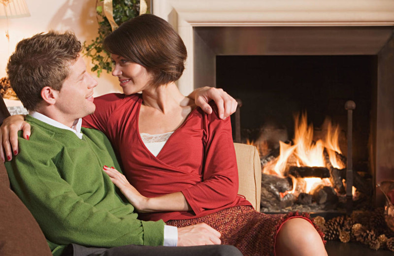 Couple by the fire at Eaglewood Resort & Spa.