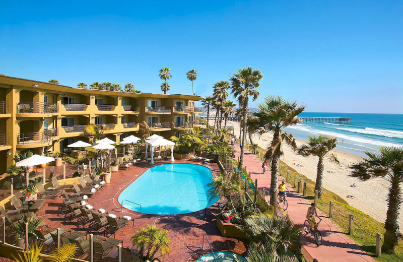 Outdoor pool and beach at Pacific Terrace Hotel.
