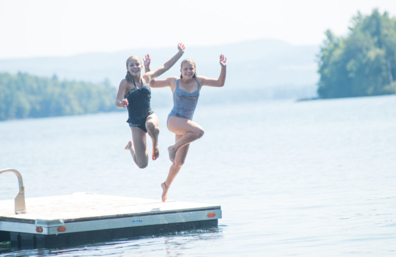 Kids jumping in lake at Mill Falls at the Lake.