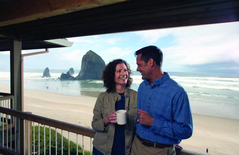 Couple on balcony at Hallmark Resort in Cannon Beach.