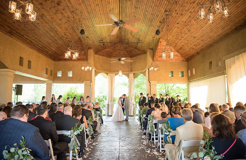 A beautiful indoor wedding ceremony amid a Tuscan-style breezeway. 