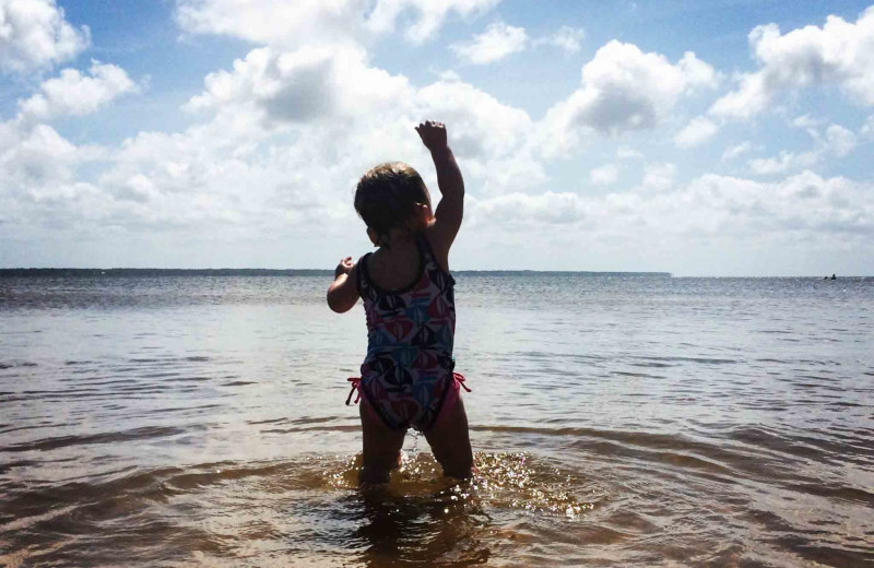 Child in water at Beach Realty & Construction.