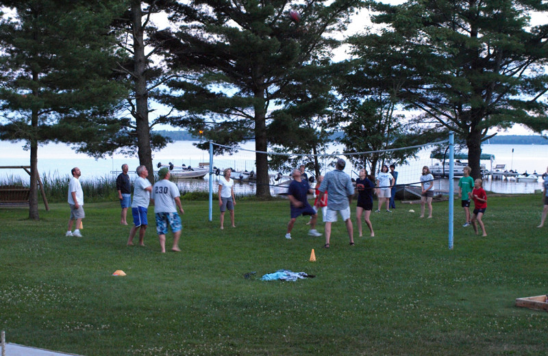 Family playing volleyball at Wind Drift Resort.