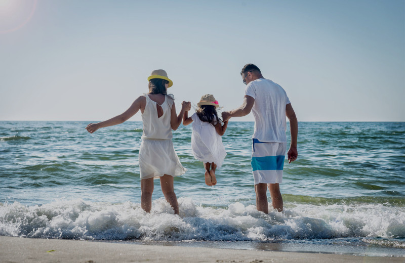 Family on beach at Caribe Resort.