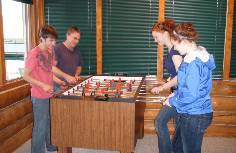 Family playing Foosball at Bear Paw Adventure.