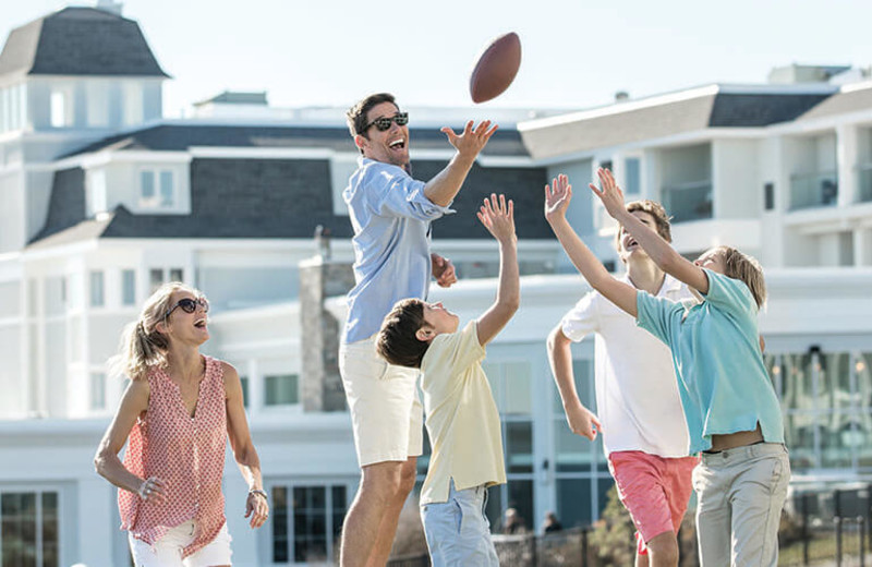 Family playing football at Cliff House Maine.