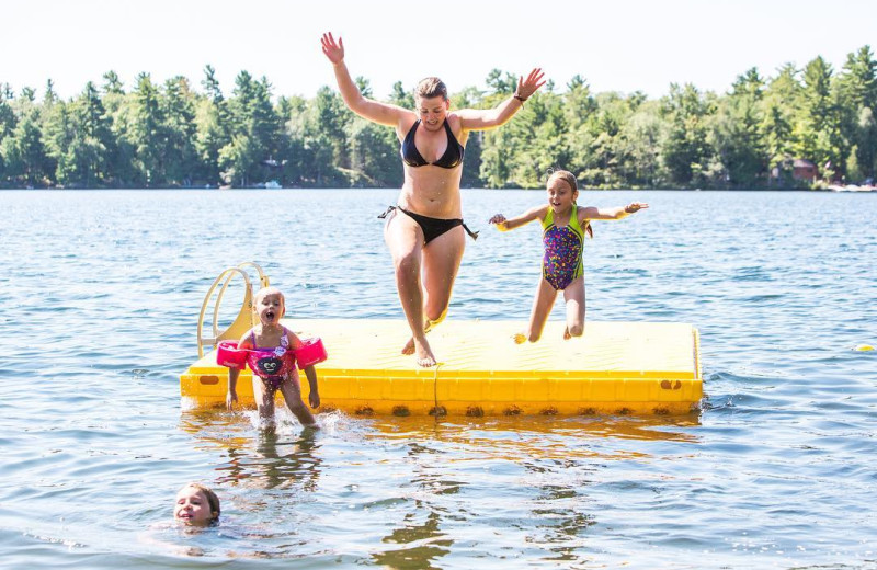 Jumping in lake at Great Blue Resorts- Lantern Bay Resort.