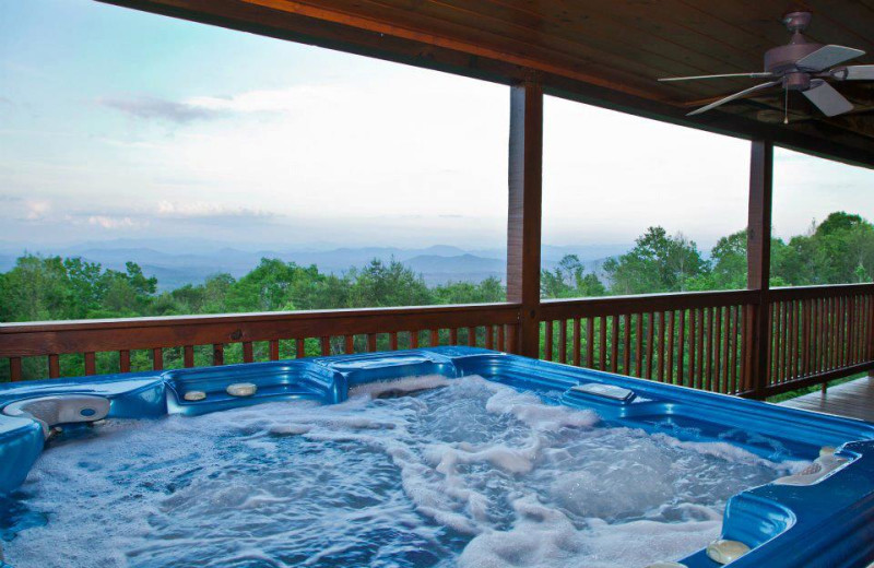 Deck jacuzzi at Mountain Getaway Cabin Rentals.