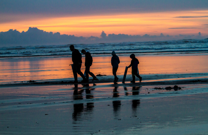 Family walking on beach at Oceanfront Getaways.